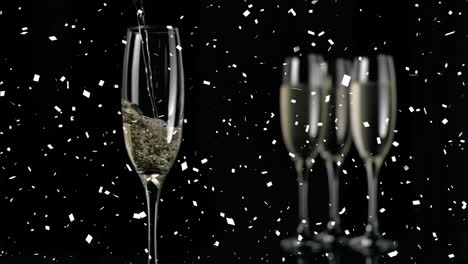 Animation-of-confetti-falling-over-champagne-glasses-on-black-background