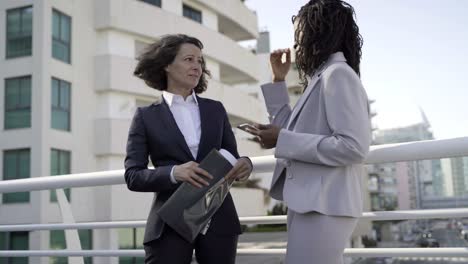 serious businesswomen with papers and tablet pc