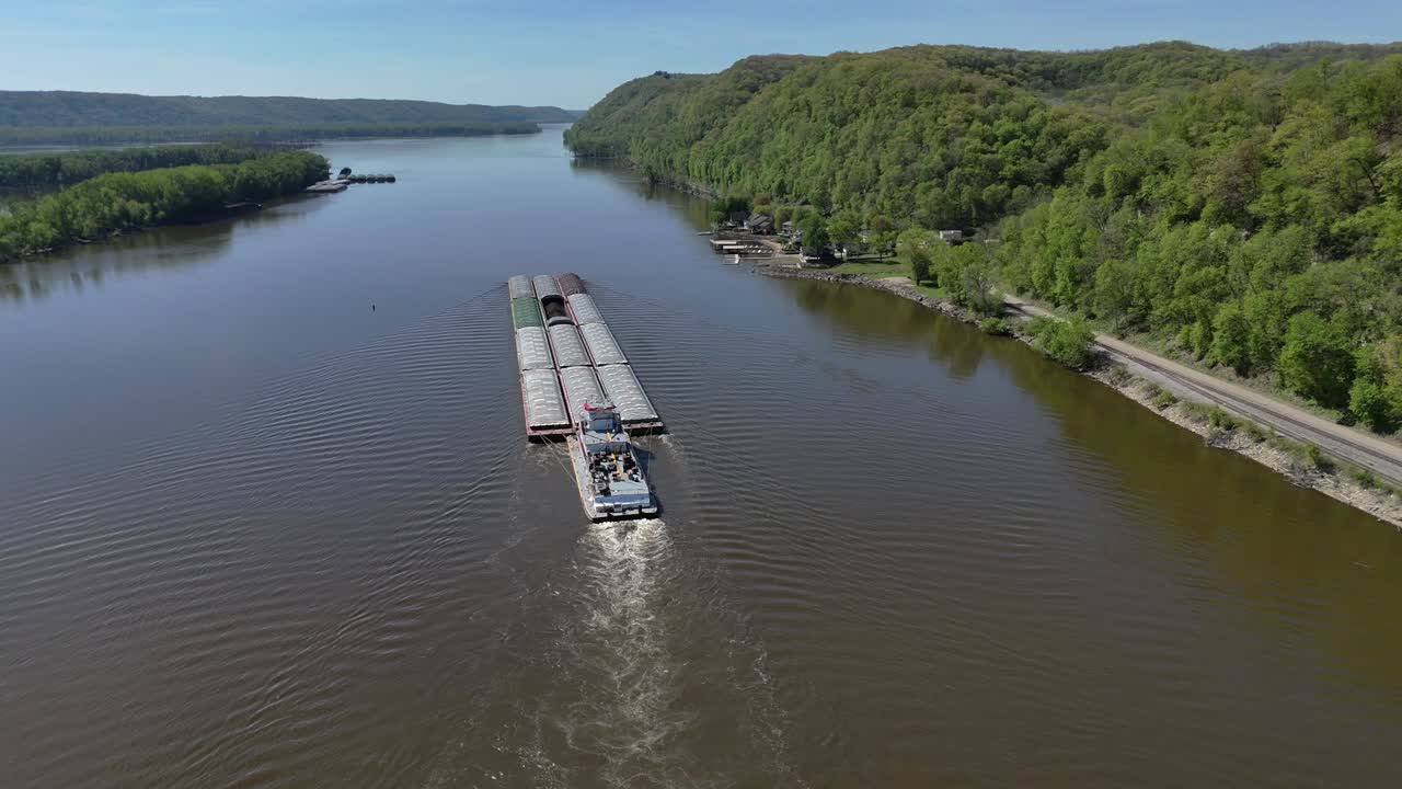 Located along the Mississippi River between Minnesota and Wisconsin's Driftless area, a towboat move a set of barges south.