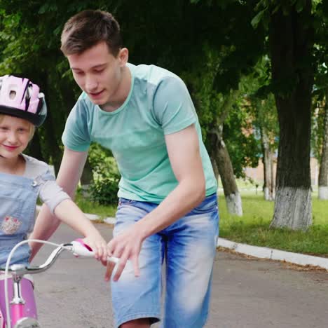 the elder brother teaches his sister how to ride a bicycle the first successes of children