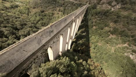 spectacular aerial fpv drone shot of ponte delle torri and albornoz fortress, italy