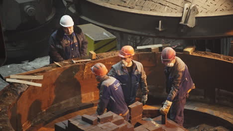 workers repairing furnace lining