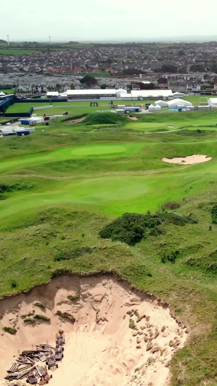 Advancing social ratio aerial video of Royal Portrush Golf Course in County Antrim, Northern Ireland, UK on a sunny day. Produced in 1080x1920 vertical ratio, 60FPS and with Rec709 color