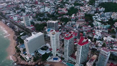 Aerial-track-shot-above-hotel-resort-in-condesa-beach-coast,-mexico-at-day