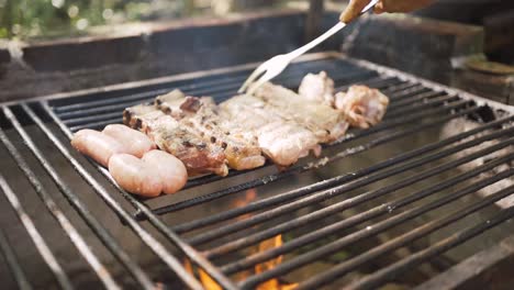 anonymous person preparing raw meat pieces above burning fire