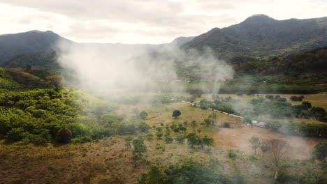 Paisaje-Aéreo-Brumoso-Del-Campo-En-Vietnam,-Vistas-A-Las-Montañas-A-La-Luz-De-La-Mañana-Al-Atardecer