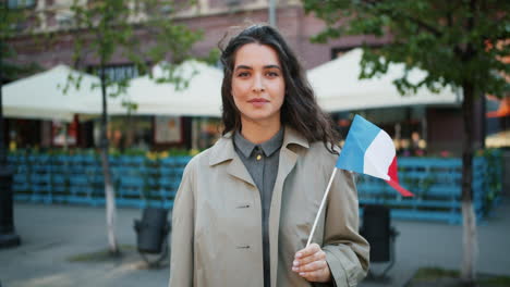woman holding french flag in city