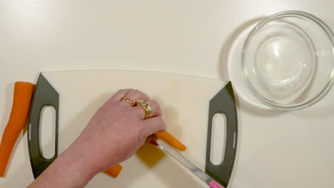 woman's hands chopping carrots - speed ramp up and down