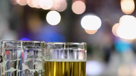 focused beer glasses with a backdrop of colorful bokeh lights, creating a vibrant and festive atmosphere.