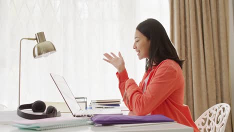 Video-of-smiling-biracial-woman-with-dark-hair-on-laptop-video-call