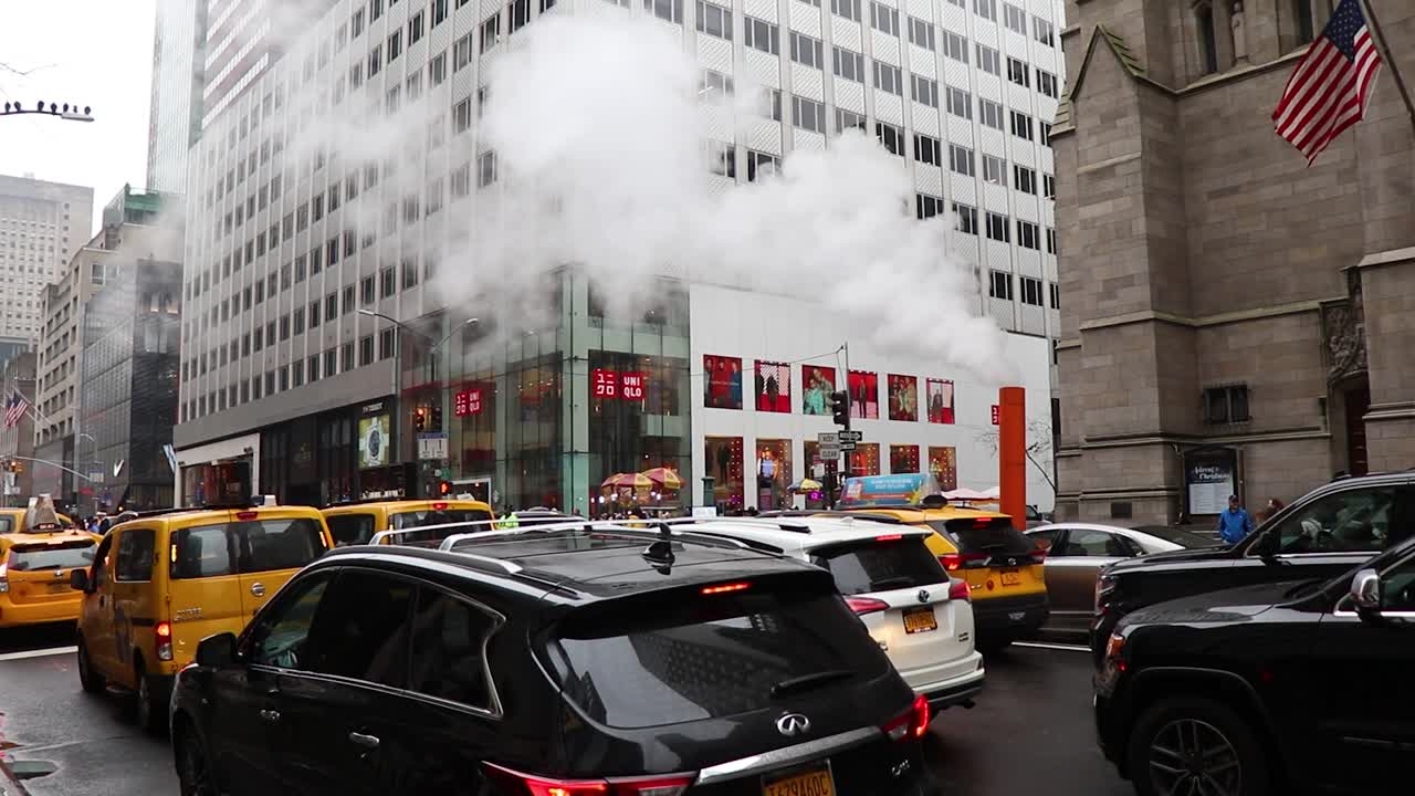 A static view of major crosstown street in the New York City borough of Manhattan. Lots of car are seen parking at the side of that road