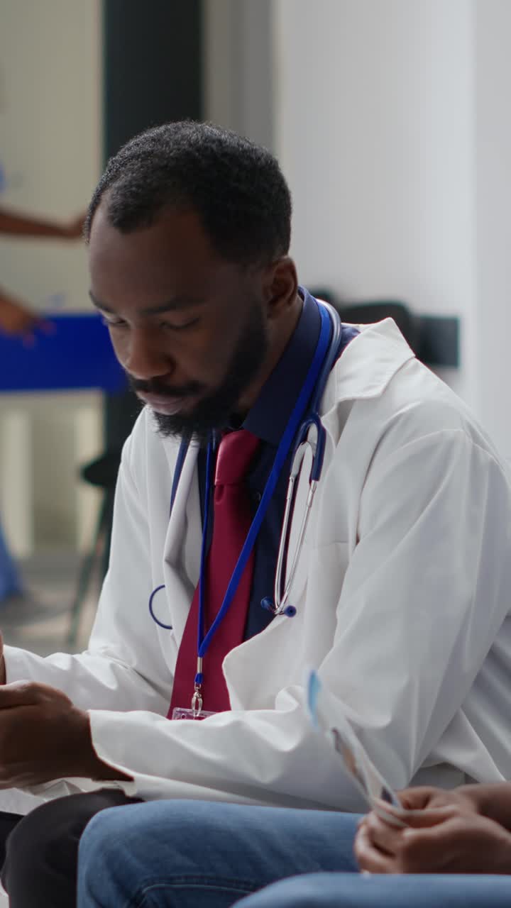 Vertical video: General practitioner giving medicare advice to sick man
