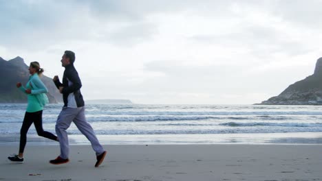 Mature-couple-jogging-on-beach