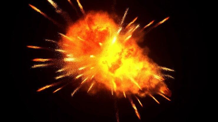 Close view of fiery burst with bright yellow core, orange flames and scattered sparks expanding from center into dark black space, delivering intense cinematic energy and danger, with fire, explosion