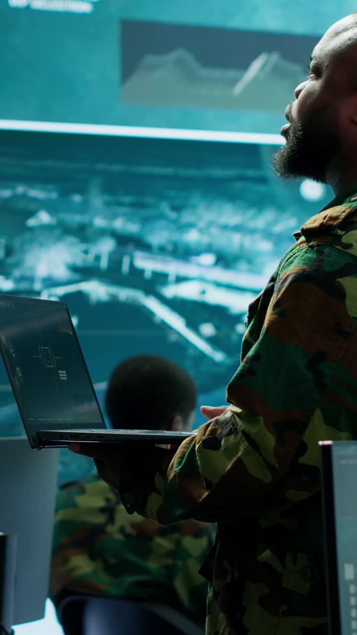 Vertical Video Military specialists work in a high tech command post center