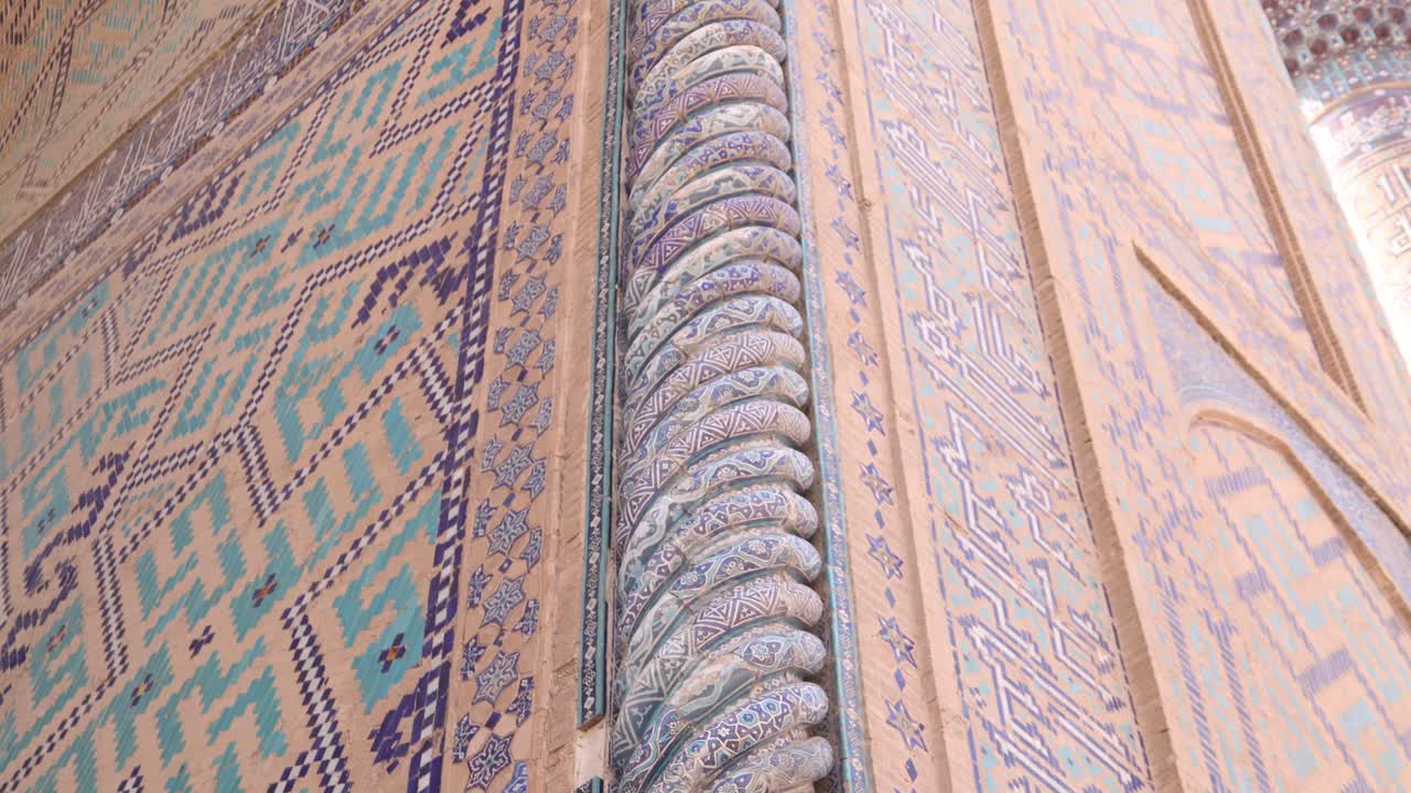 ornate spiraling blue column on the front of madrassa in Samarkand, Uzbekistan along the historic Silk Road