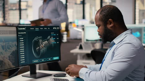Technician Working On Wind Turbine Simulation In Office, Doing Upgrades