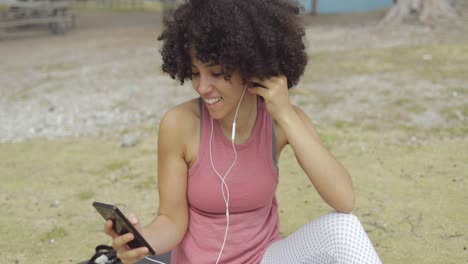 Charming-girl-having-videocall-on-mat-in-park