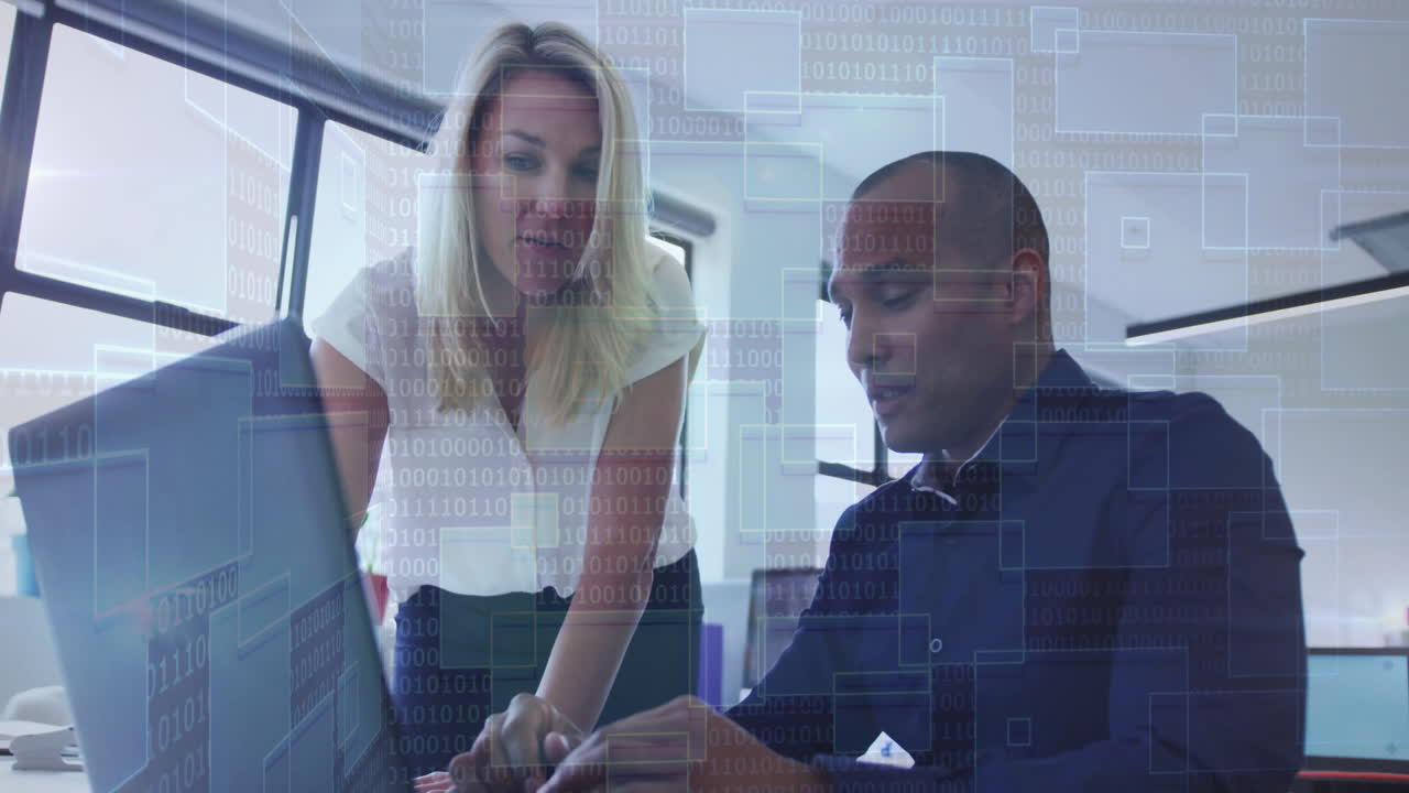 Business professionals working on laptop with digital binary code overlay animation