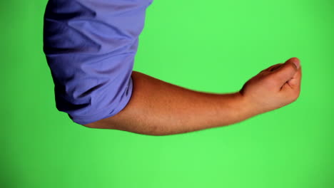 an arm in front of a green screen to be keyed and used at will