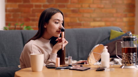 woman applying makeup at home