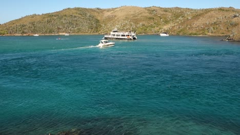 tourist catamaran and speedboat sailing on sea channel at cabo frio coast in brazil