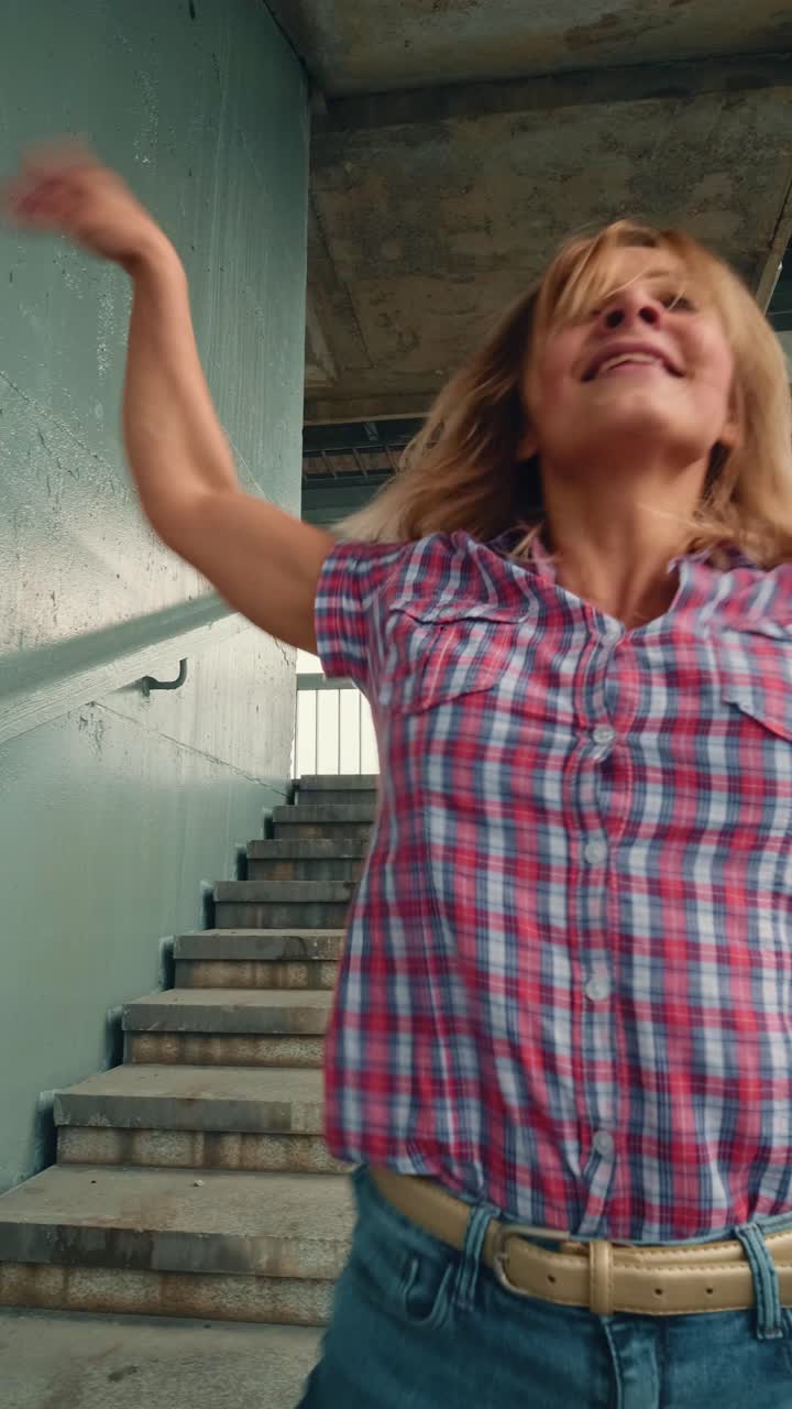 Woman Dancing on Stairs in Urban Setting