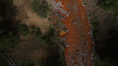 Aerial-cinematic-drone-orange-river-Cement-Creek-summer-high-altitude-Silverton-Ski-Area-resort-Telluride-Prospect-Gulch-Colorado-Rocky-Mountains-stunning-drive-looking-down-steam-close-up-movement