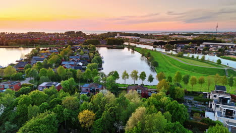 striking panorama of a picturesque green village with multiple canals. drone flight over amazing landscape at sunset time.