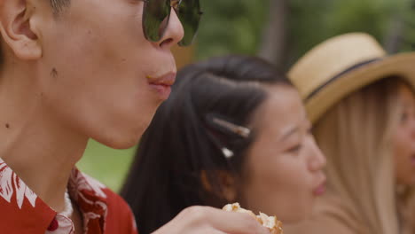 man eating fast food outdoors