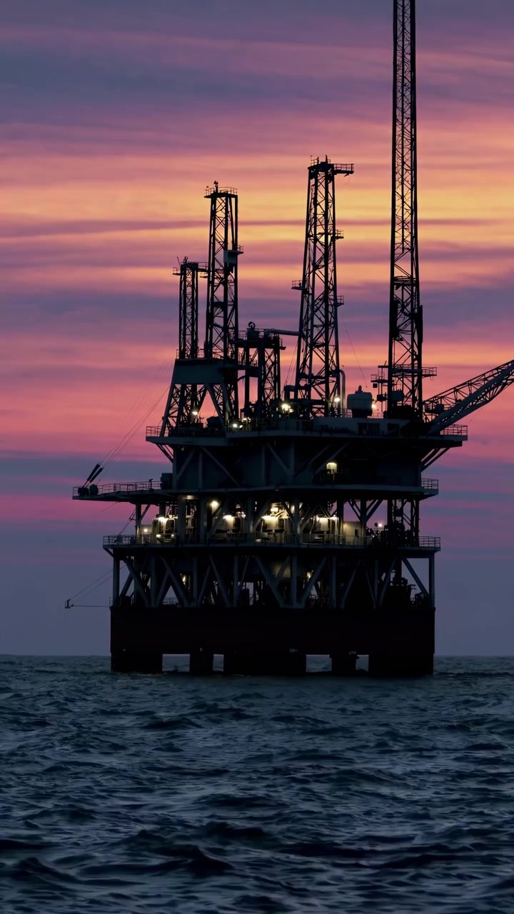 Offshore Oil Rig Silhouette Against a Vibrant Sunset
