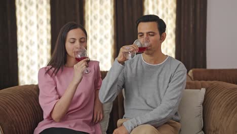 una pareja india rica bebiendo vino.
