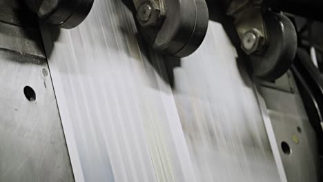 newspapers move along an overhead conveyor belt at a newspaper factory 13