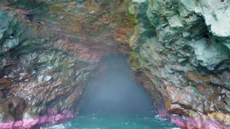 4k hawaii kauai boating on ocean floating away from entrance of cave