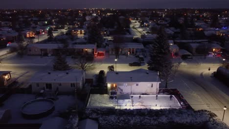 winter cityscape of the snow-covered saint-constant village with streets and glowing houses lights, quebec, canada.