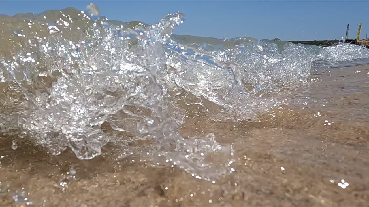 Splashing Waves With Floating Rubbish Over Shore