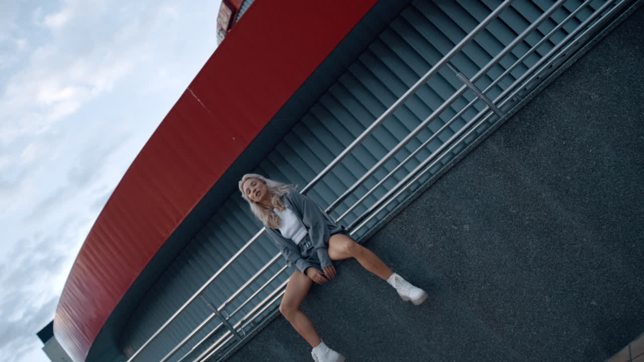 Confident woman sitting building architecture at evening or early morning.