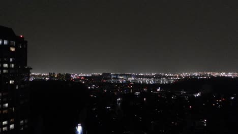 Busy-city-at-night-as-traffic-moves-through-the-streets