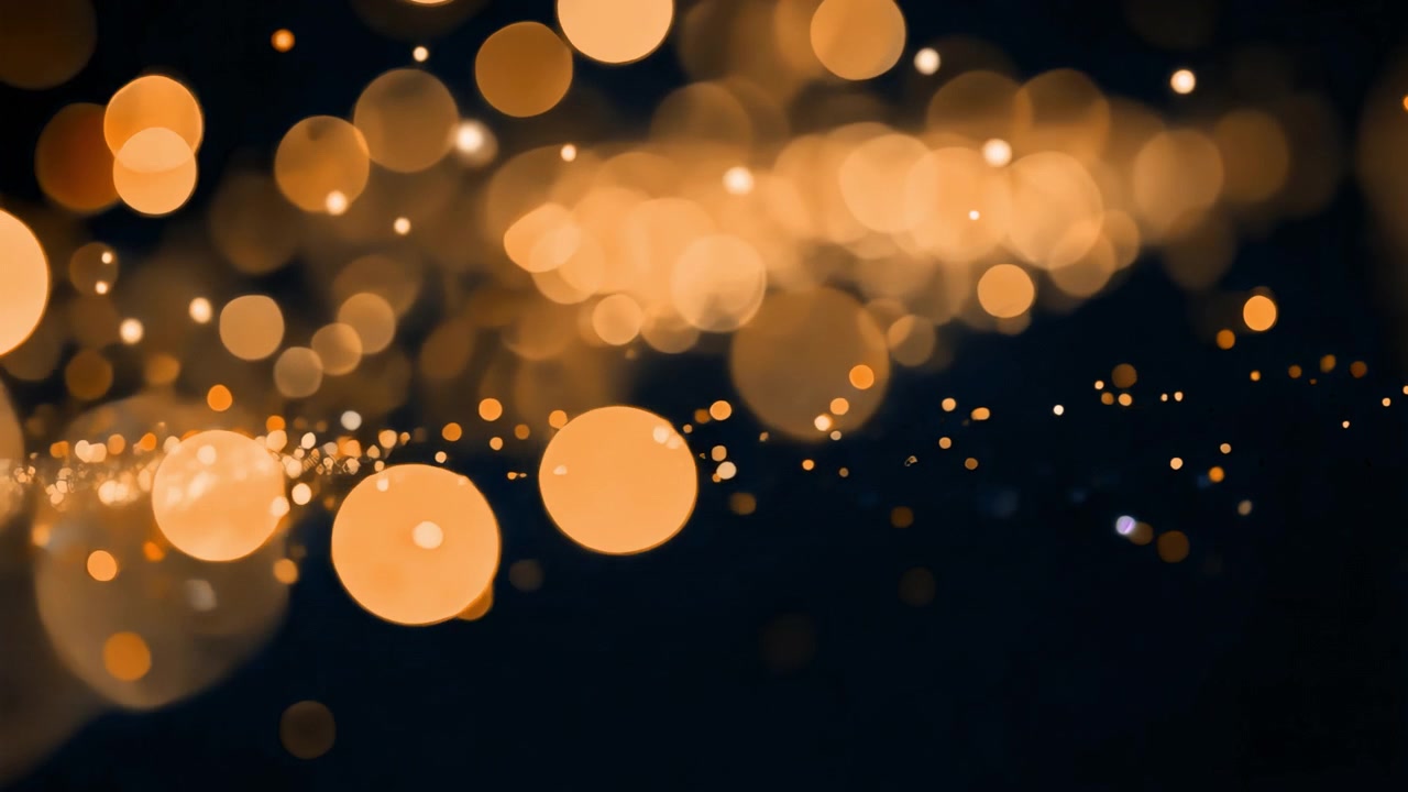 Particelle di luce bokeh dorate che fluttuano su sfondo scuro