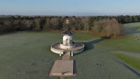 an aerial view of the peace pagoda at willen lake in milton keynes, on a cold winter morning with the sun shining