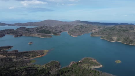 Aerial-shot-of-unique-shore-formations-over-lake-Plastira-in-Greece-|-4K