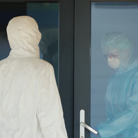 a courier in a protective suit hands the doctor a red case with valuable medicines