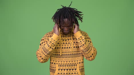 young handsome african man having headache