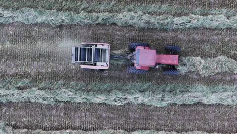 a farmer collects hay into a round hay baler in northeast wisconsin