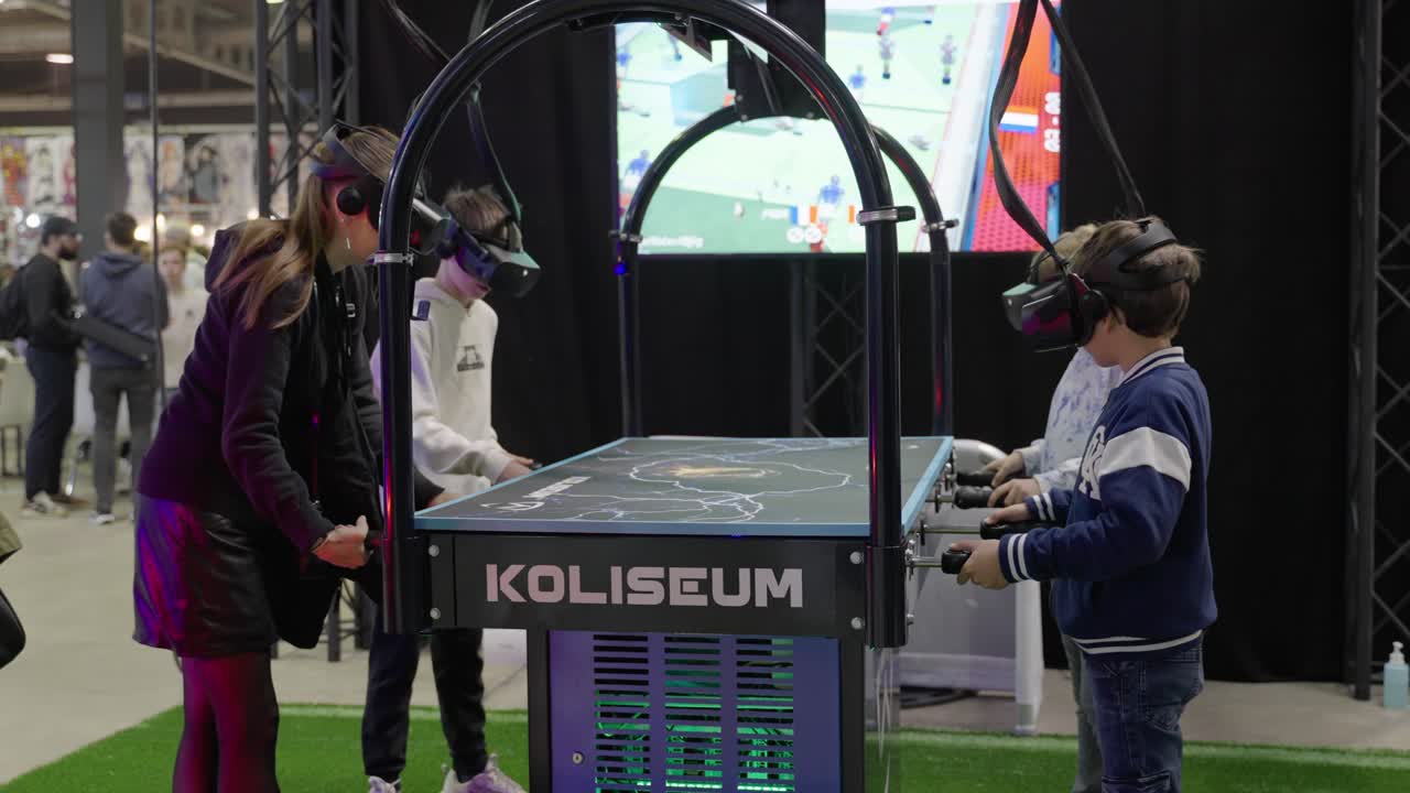 Group of Kids playing virtual reality VR table soccer with googles on at a convention event having fun at LGX Luxembourg