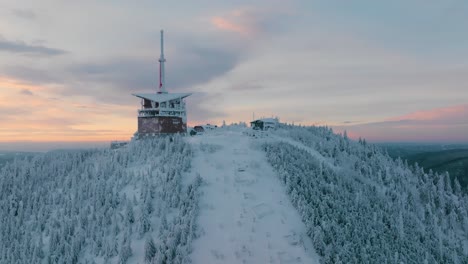 Lysa-hora-during-winter-sunrise,-Pan-up-drone-reveal,-Beskydy-UHD