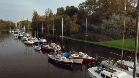 reveal shot of un manned sailing boats on canal