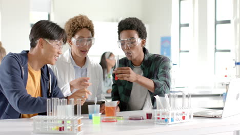 in high school, teenagers conducting science experiment with test tubes in classroom