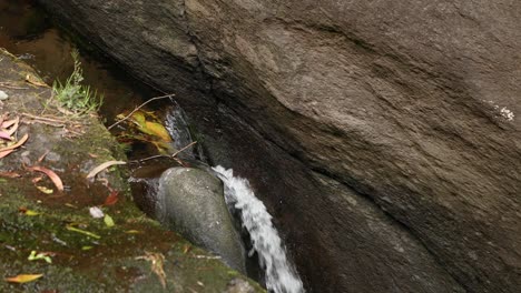 Cascade-Of-Water-Flowing-Between-Rocks-In-Parque-das-Frechas-In-Portugal---high-angle