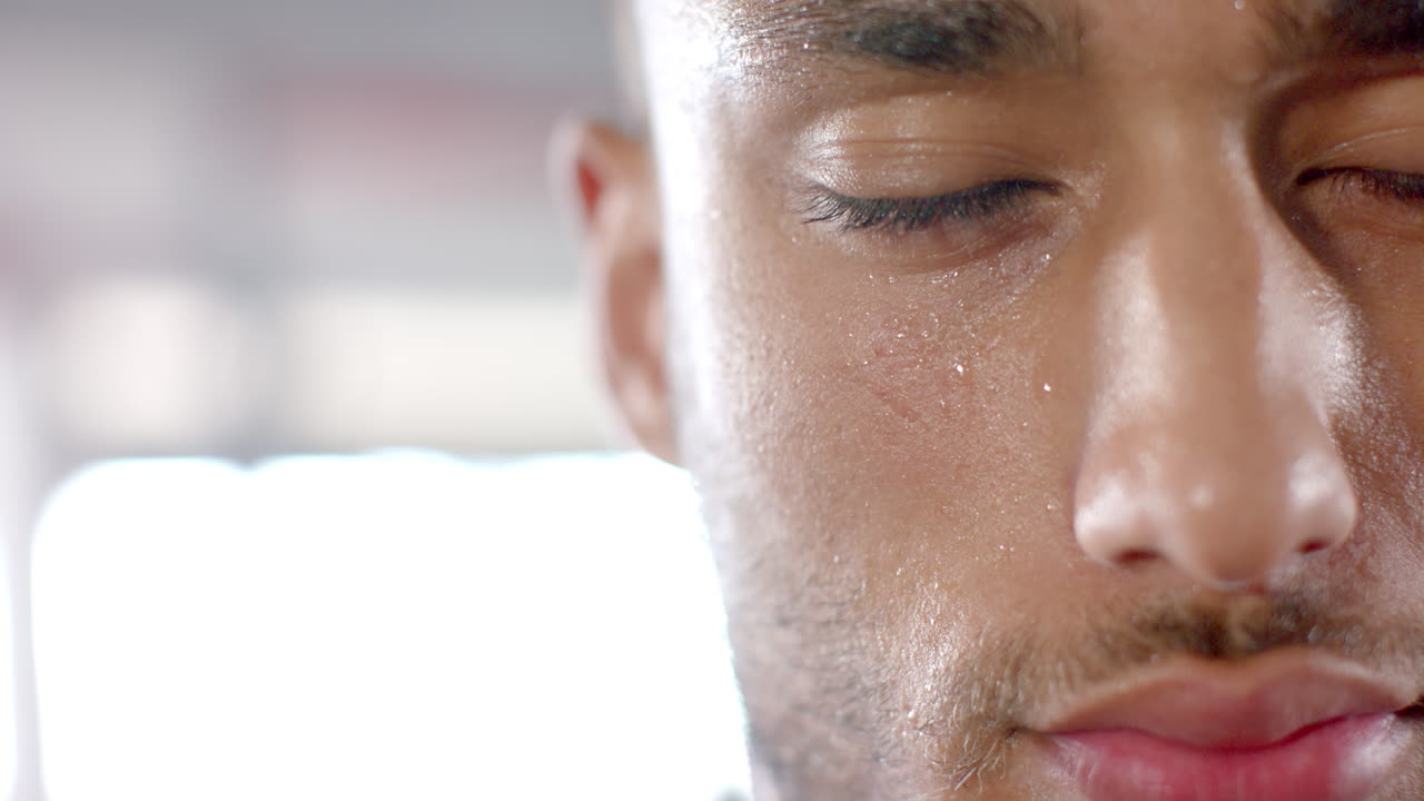 Sweating and focusing, man in gym during intense workout session, copy space